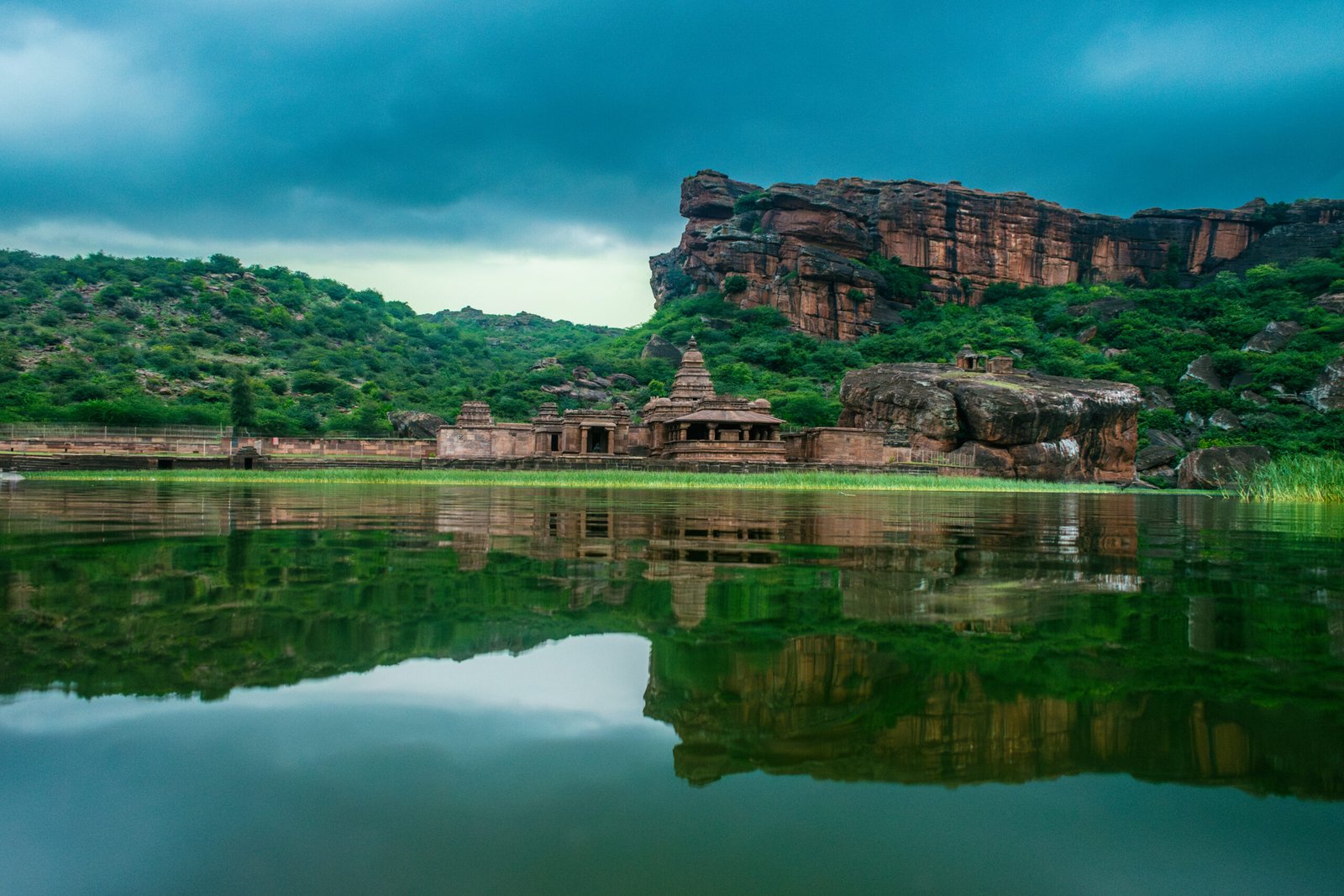 A scenic view of the Bhutanatha group of temples in Badami, Karnataka, beautifully reflected in Agastya Lake.